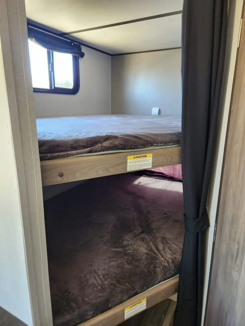 A view of the bottom bunk in a cabin.