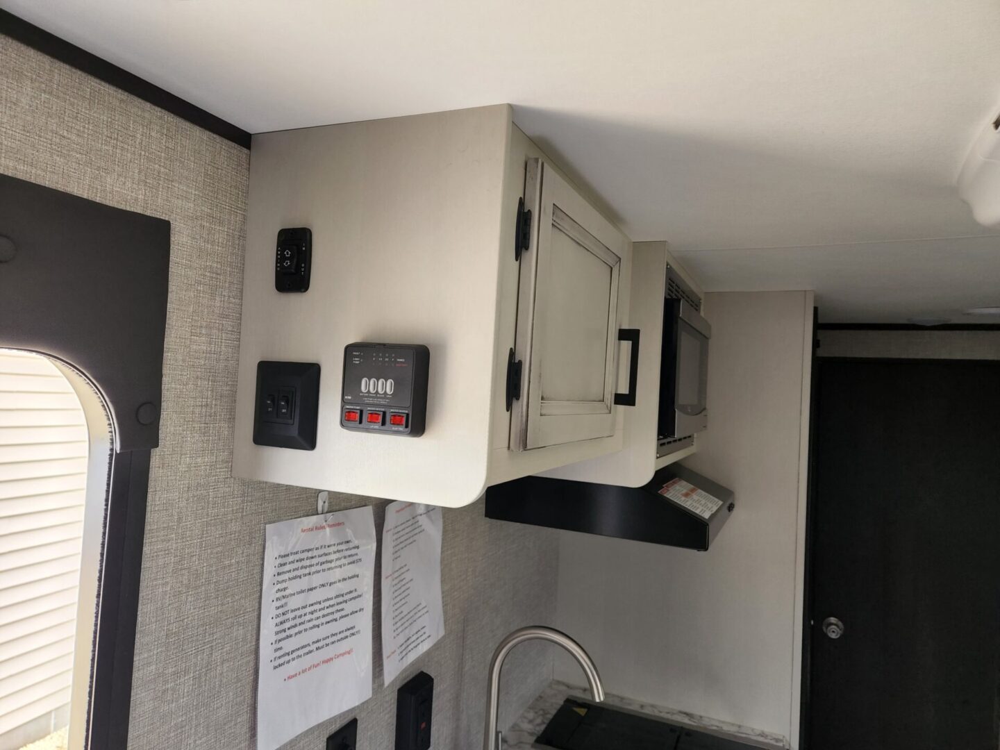 A microwave oven sitting on top of a wall.