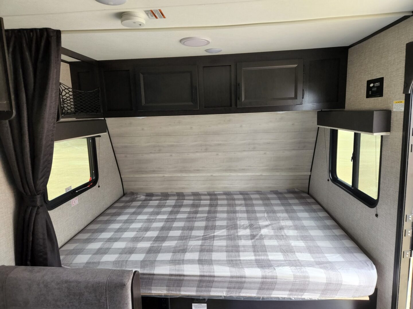 A bed in the back of an rv.